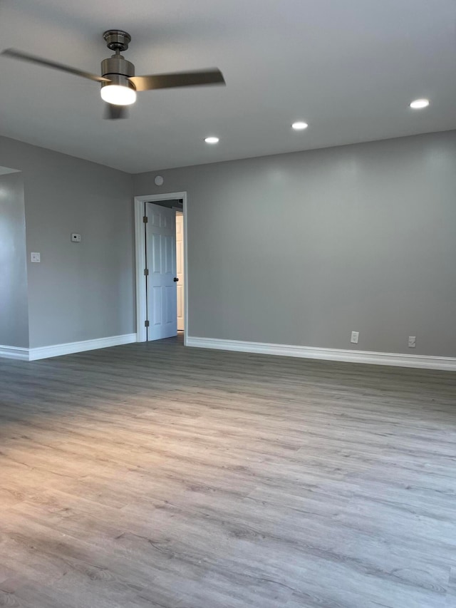 empty room with light hardwood / wood-style floors and ceiling fan