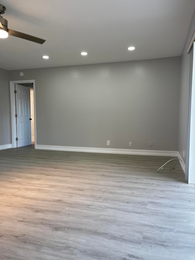 unfurnished room featuring ceiling fan and light hardwood / wood-style flooring