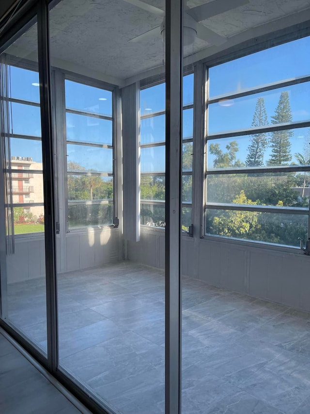 unfurnished sunroom with plenty of natural light