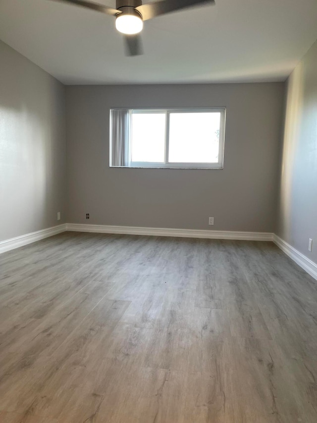 unfurnished room with wood-type flooring and ceiling fan