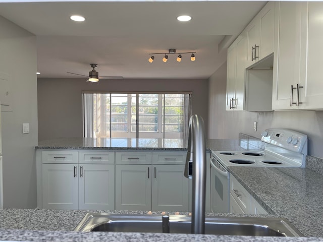 kitchen featuring electric stove, ceiling fan, light stone counters, and white cabinetry