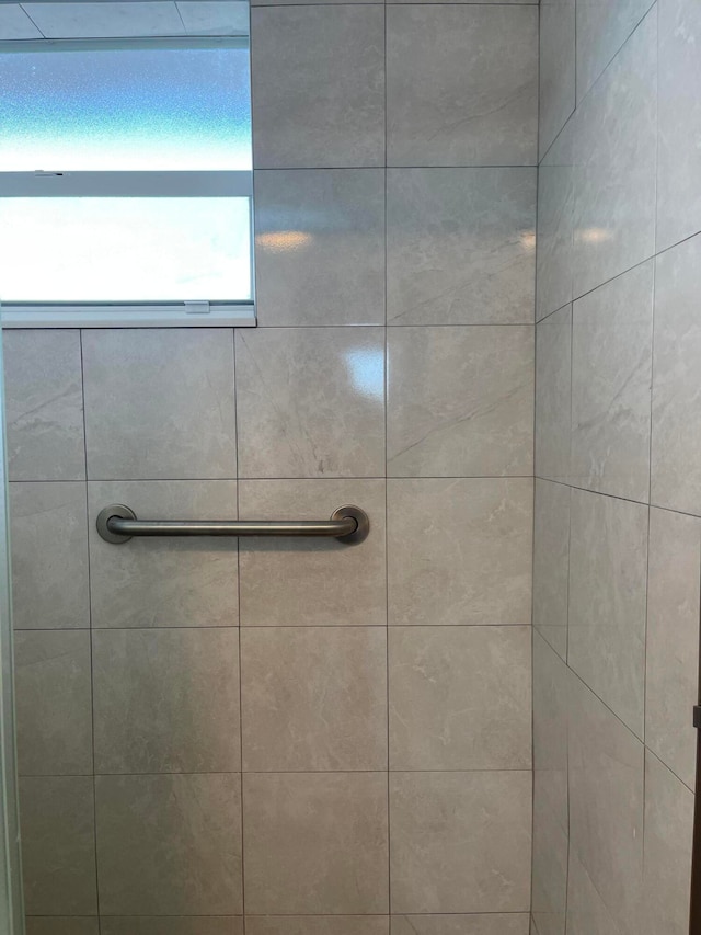 bathroom with tiled shower