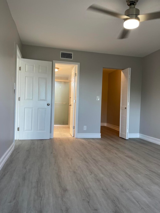 unfurnished bedroom with ceiling fan, a closet, and light hardwood / wood-style floors