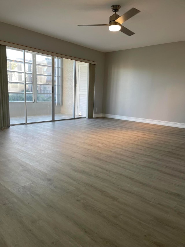 unfurnished room featuring ceiling fan and hardwood / wood-style floors