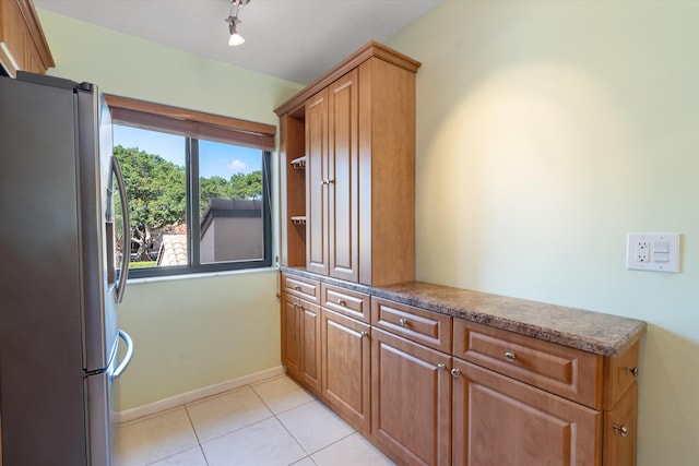 kitchen featuring stainless steel fridge and light tile patterned floors