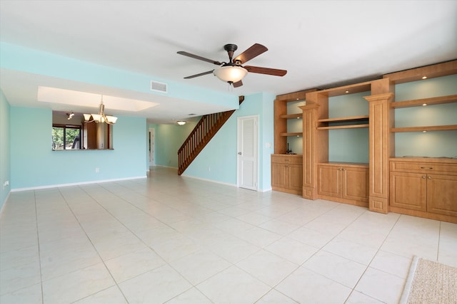 unfurnished living room featuring light tile patterned flooring and ceiling fan with notable chandelier