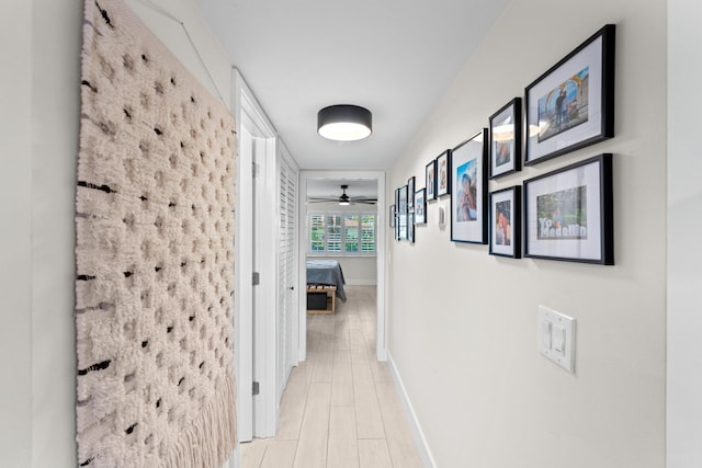 corridor with light hardwood / wood-style floors