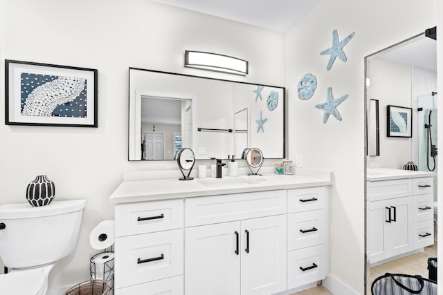 bathroom featuring wood-type flooring, vanity, and toilet