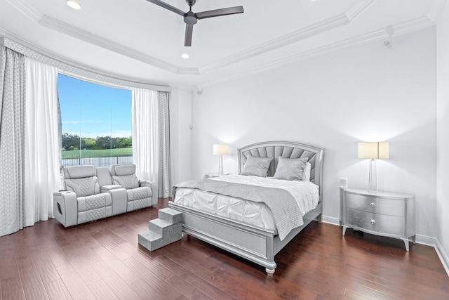 bedroom with a tray ceiling, ceiling fan, crown molding, and dark hardwood / wood-style flooring