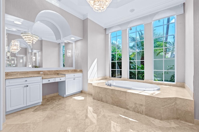 bathroom featuring tiled tub, vanity, ornamental molding, and an inviting chandelier