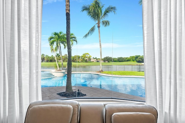 view of swimming pool featuring a water view