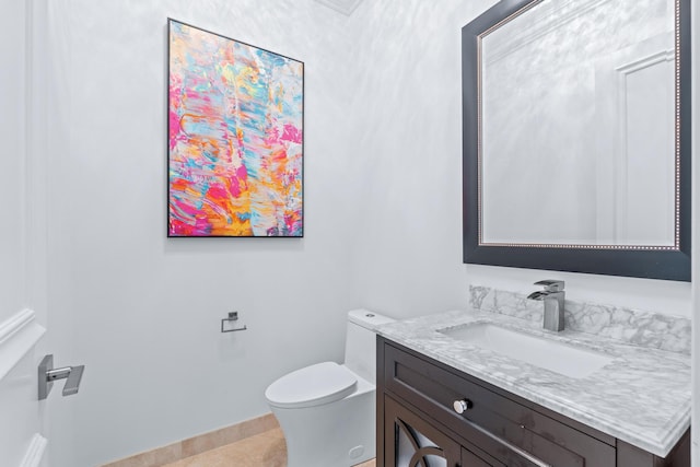 bathroom featuring vanity, toilet, and tile patterned floors