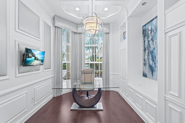 sitting room featuring an inviting chandelier, dark hardwood / wood-style floors, and crown molding