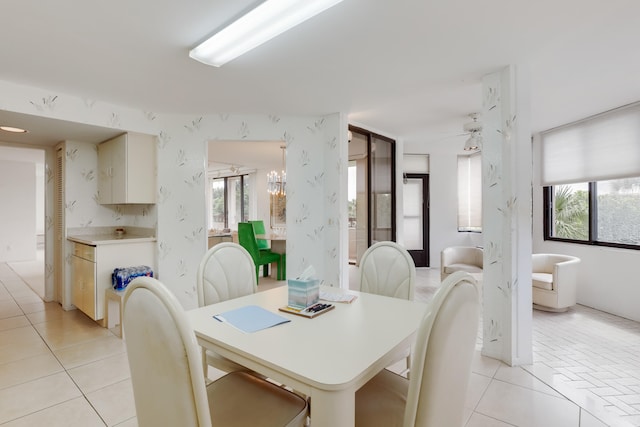 tiled dining space with ceiling fan