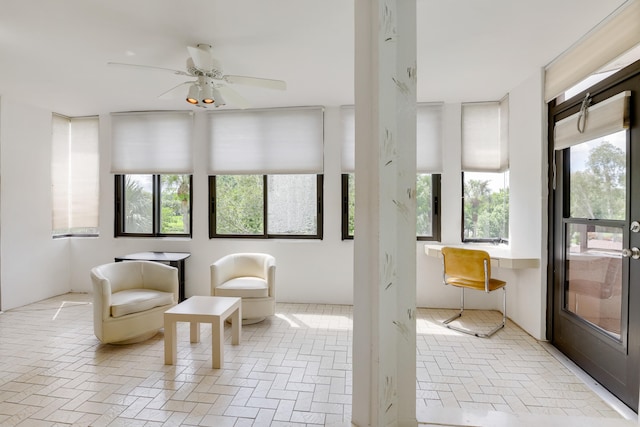 sunroom / solarium with ceiling fan and a healthy amount of sunlight