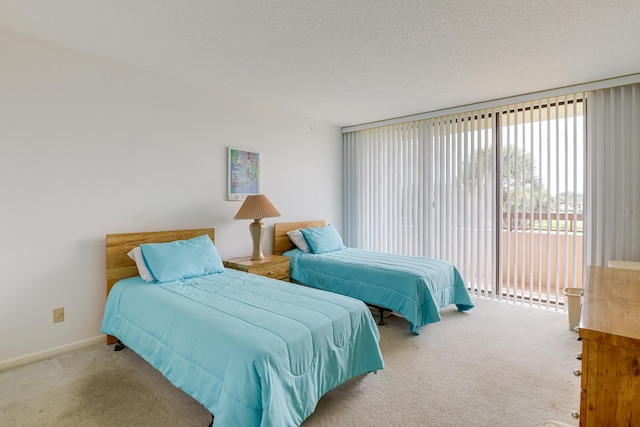 carpeted bedroom with access to outside and a textured ceiling