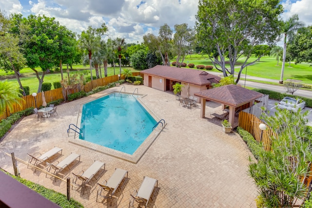 view of pool with a lawn and a patio area