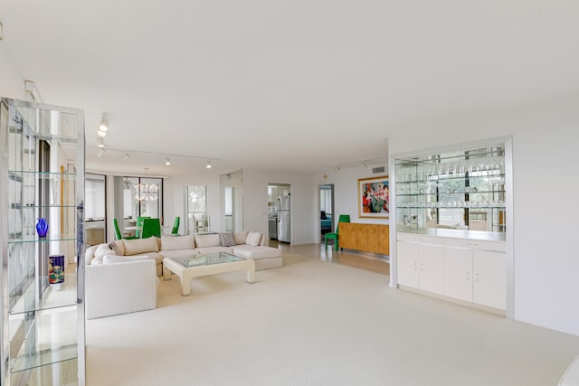 unfurnished living room with light colored carpet