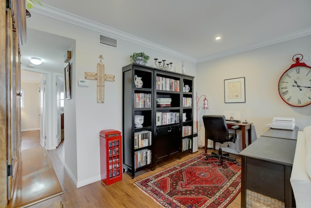 home office featuring ornamental molding and light hardwood / wood-style flooring