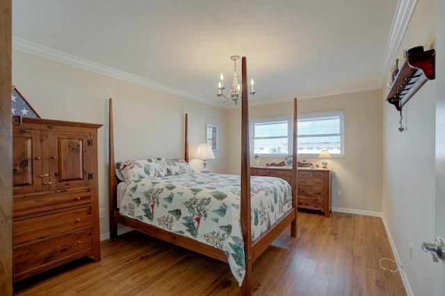 bedroom featuring a chandelier, hardwood / wood-style floors, and crown molding