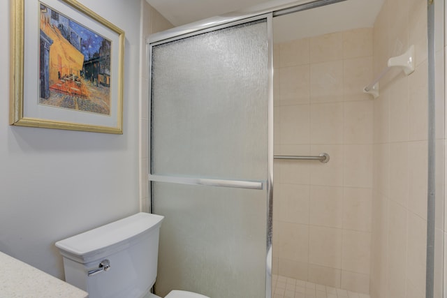 bathroom with toilet and a shower with door