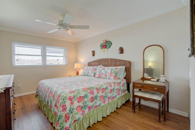 bedroom featuring ornamental molding, hardwood / wood-style floors, and ceiling fan