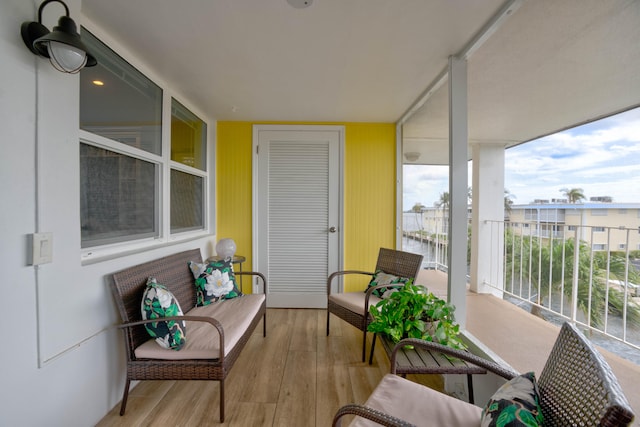 sunroom featuring a water view and a healthy amount of sunlight