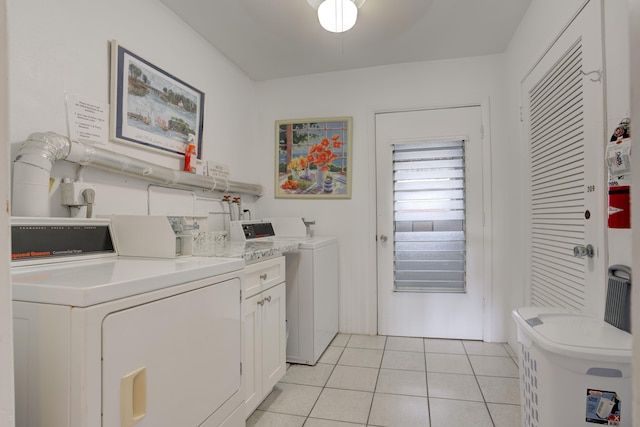 laundry area with light tile patterned floors and independent washer and dryer