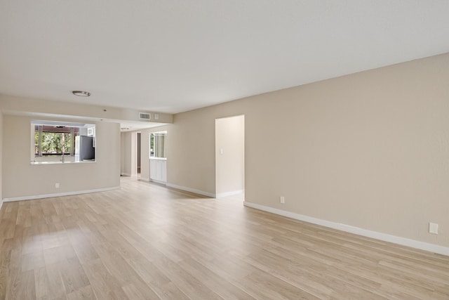 spare room with light hardwood / wood-style floors