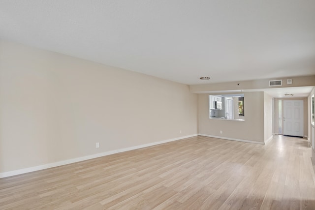 spare room featuring light hardwood / wood-style flooring