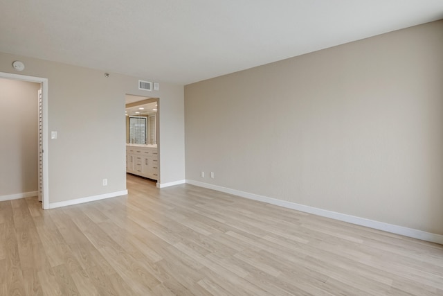 spare room featuring light wood-type flooring