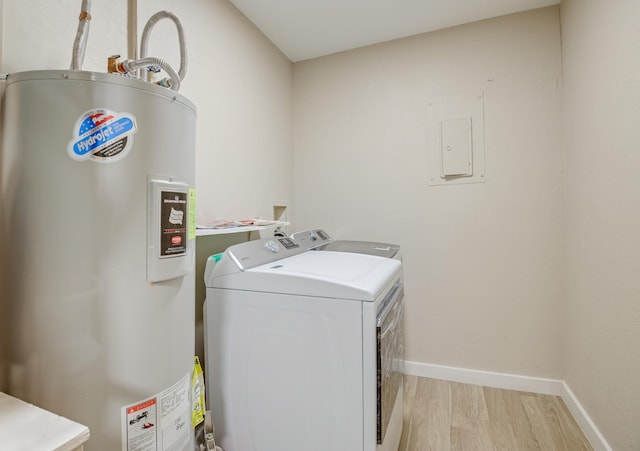 laundry area featuring light wood-type flooring, water heater, electric panel, and washer and clothes dryer