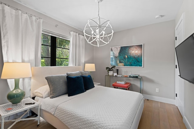 bedroom featuring a chandelier and hardwood / wood-style floors