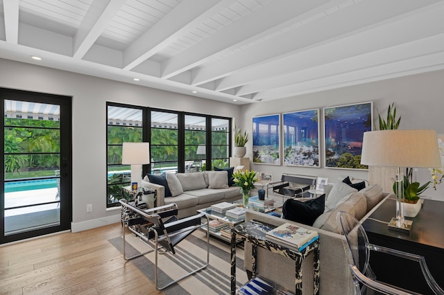 living room with beam ceiling and light hardwood / wood-style floors