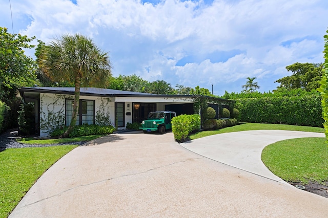 single story home with a front lawn and a carport