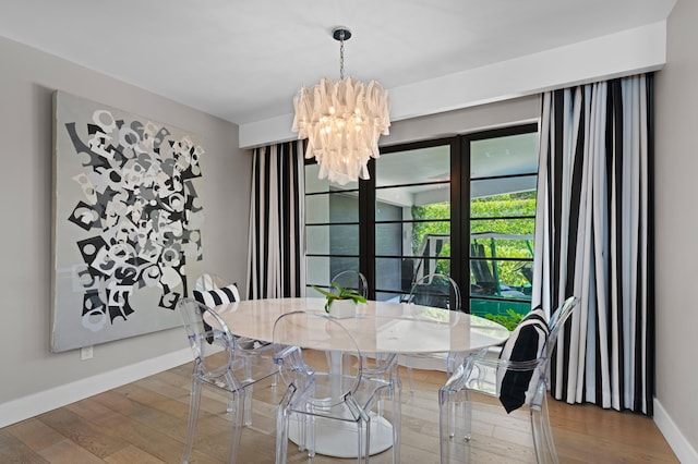 dining room with a notable chandelier and wood-type flooring