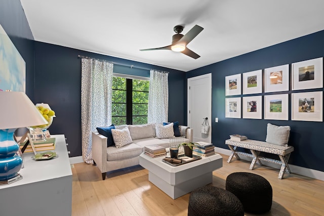 living room featuring ceiling fan and light wood-type flooring