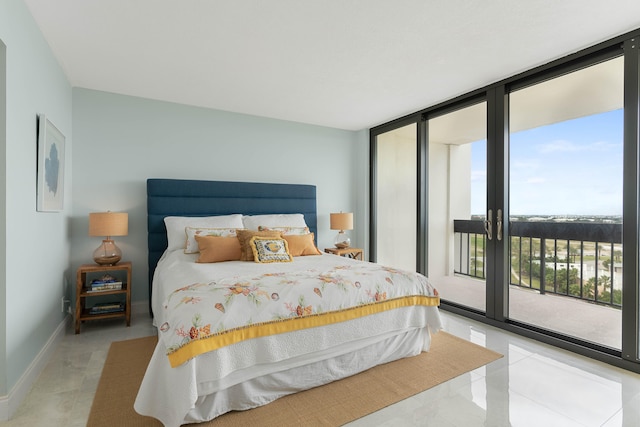 tiled bedroom featuring expansive windows, access to exterior, and multiple windows