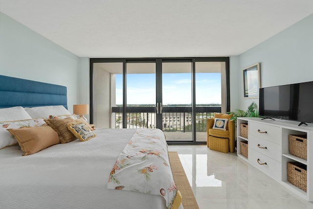 bedroom featuring multiple windows, floor to ceiling windows, and access to exterior