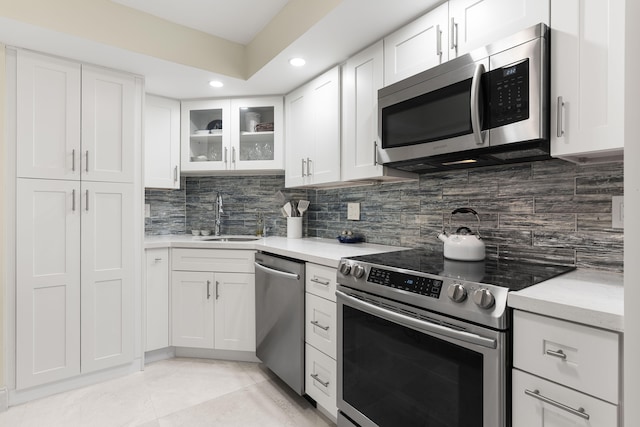 kitchen with white cabinets, appliances with stainless steel finishes, and sink