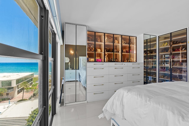 bedroom with a view of the beach and a water view