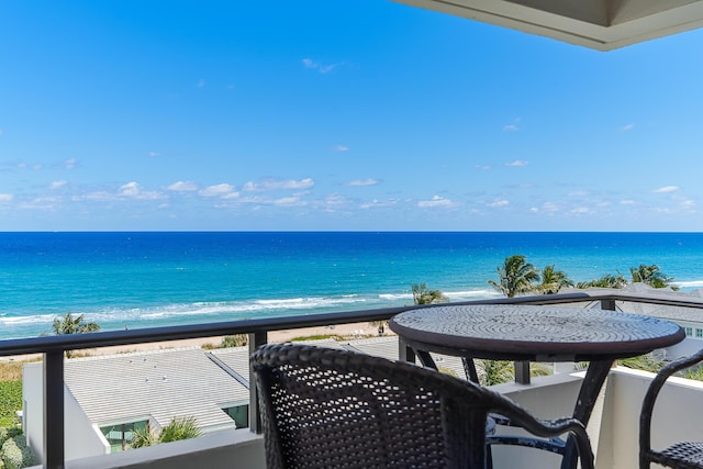 balcony with a water view and a beach view