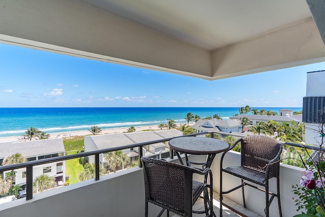 balcony featuring a water view and a beach view