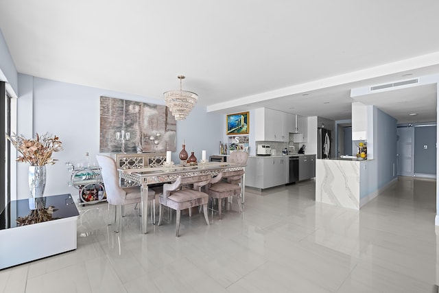 tiled dining area with a notable chandelier and sink