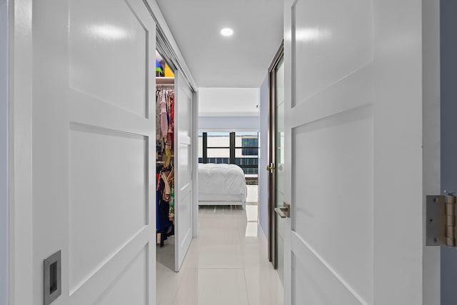 corridor featuring light tile patterned floors