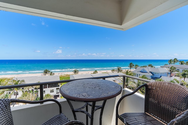 balcony featuring a water view and a beach view