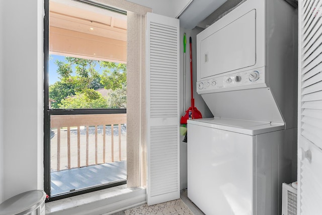 clothes washing area with stacked washer and clothes dryer