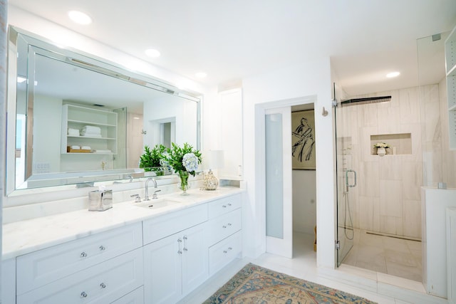 bathroom with an enclosed shower, tile patterned floors, and vanity