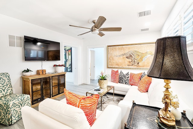 living room with ceiling fan and wood-type flooring