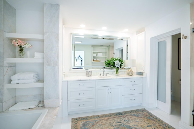 bathroom with a relaxing tiled tub, vanity, tile patterned floors, and built in shelves